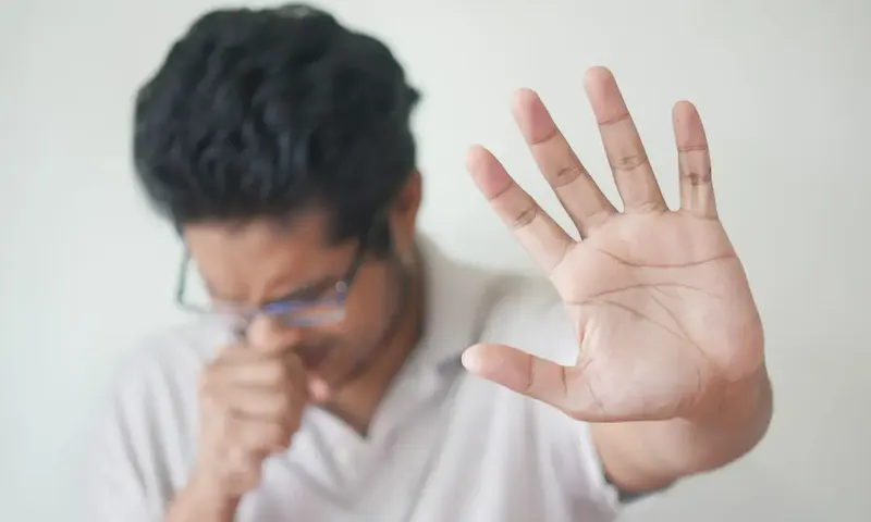 a man holding his hand up in front of his face | Photo by Towfiqu barbhuiya, on https://unsplash.com/@towfiqu999999?utm_source=centralapp&utm_medium=referral