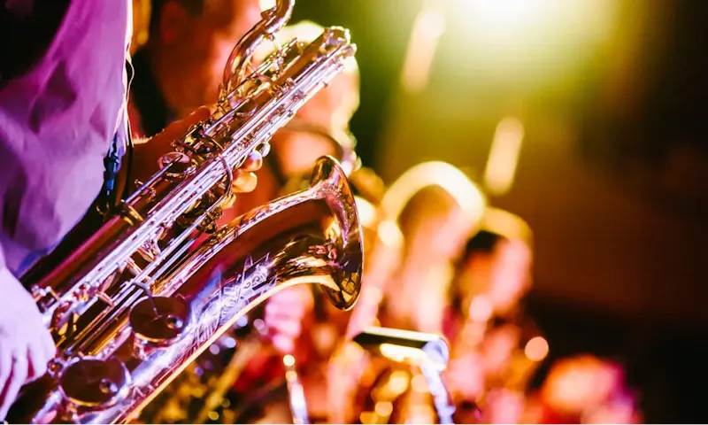 Image of Last Outpost person playing saxophone | Photo by Jens Thekkeveettil, on https://unsplash.com/@jensth?utm_source=centralapp&utm_medium=referral