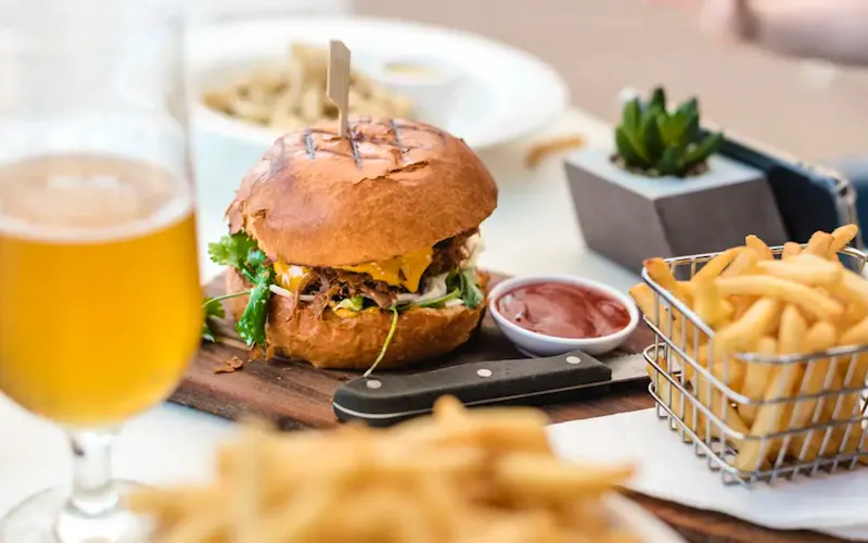 selective focus photography of burger and fries | Photo by Melissa Walker Horn, on https://unsplash.com/@sugercoatit?utm_source=CentralApp&utm_medium=referral