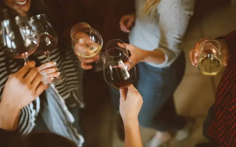 Image of La Bella Krog group of people tossing wine glass | Photo by Kelsey Chance, on https://unsplash.com/@kchance8?utm_source=centralapp&utm_medium=referral