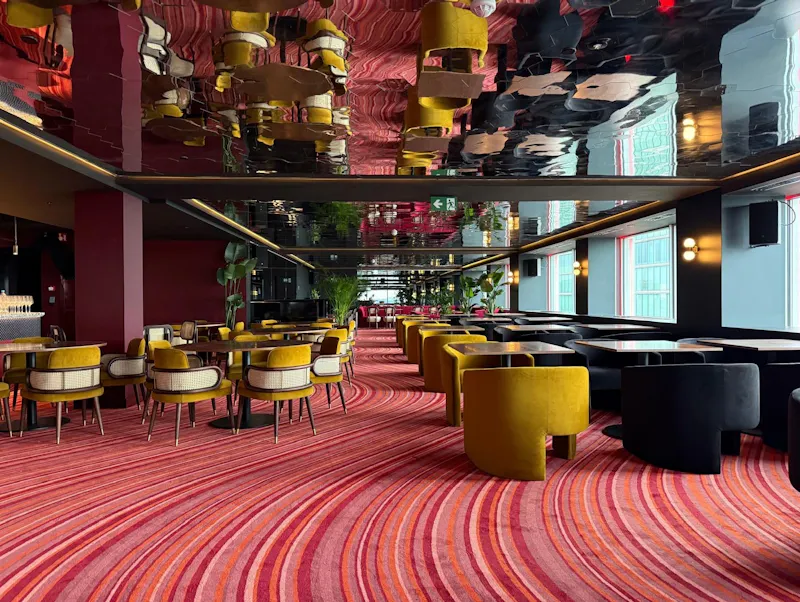 Discover Akai's three unique atmospheres: dining with skyline views, lounging in red velvet comfort, or sipping cocktails at the high table for two.
