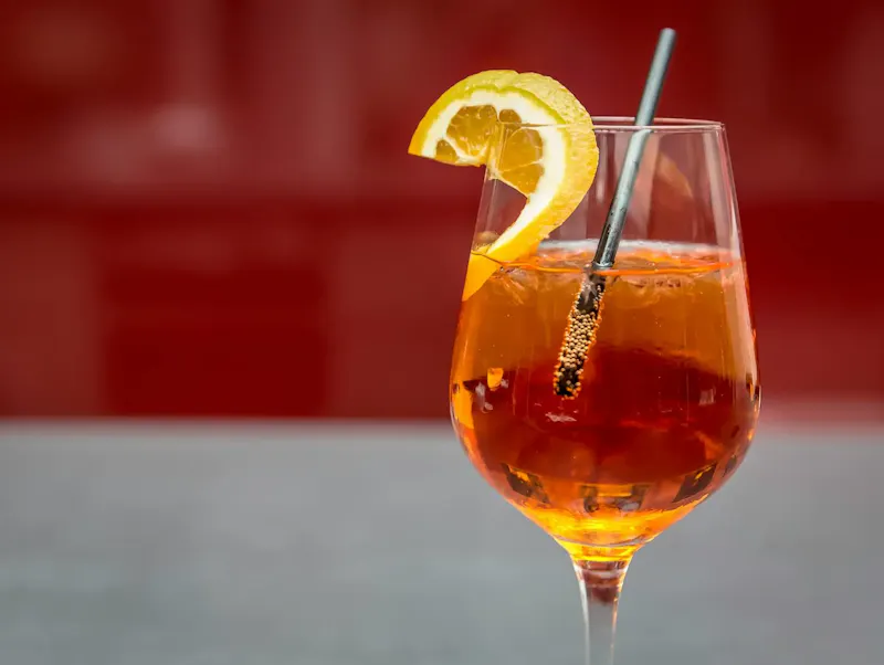 Image of Ristorante Autoespresso Bright Aperol spritz with lemon slice on a glass, perfect for summer refreshment. | Photo by Markus Spiske, on https://www.pexels.com/@markusspiske?utm_source=centralapp&utm_medium=referral