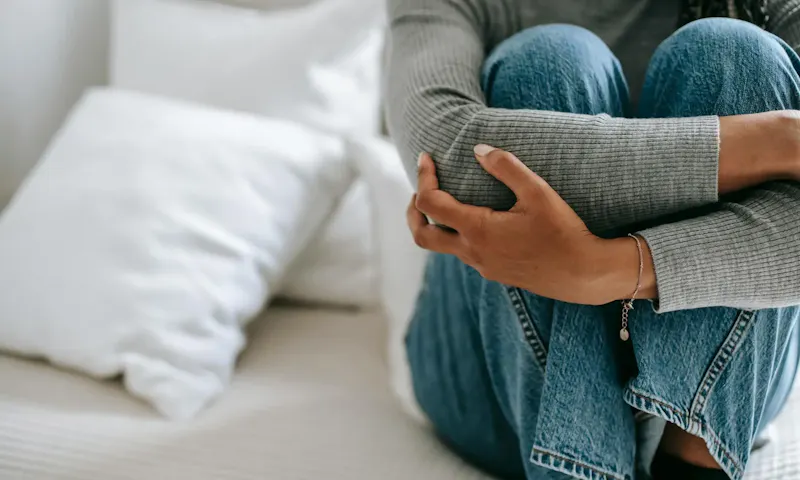 Crop faceless female feeling helpless and frustrated embracing knees while sitting on bed in loneliness | Photo de Alex Green, sur https://www.pexels.com/@alex-green?utm_source=centralapp&utm_medium=referral