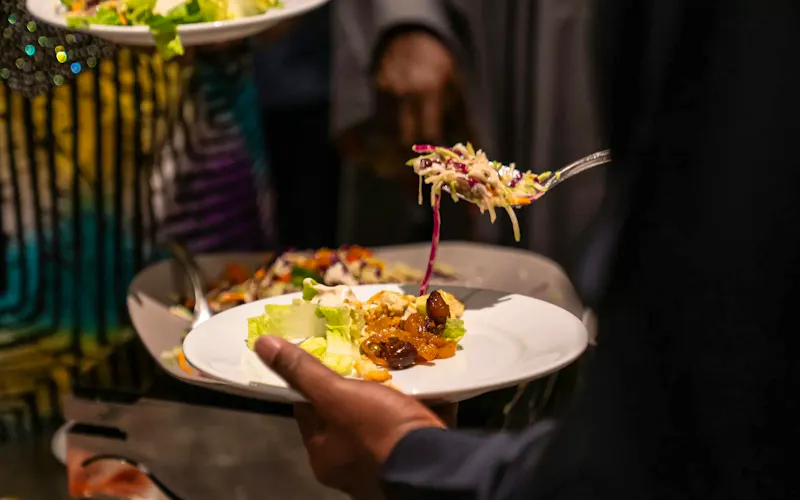 Image of La Cantoniera A close-up view of guests serving themselves diverse dishes at a buffet, highlighting culinary diversity. | Photo by Justin Agyarko, on https://www.pexels.com/@justinagyarko?utm_source=CentralApp&utm_medium=referral
