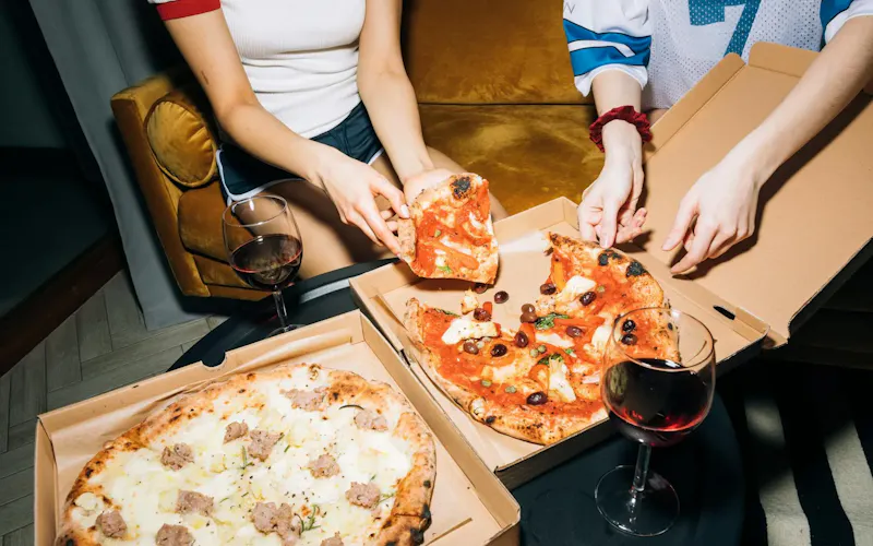 Two Person Getting a Slice of Pizza | Photo by KoolShooters, on https://www.pexels.com/@koolshooters?utm_source=centralapp&utm_medium=referral
