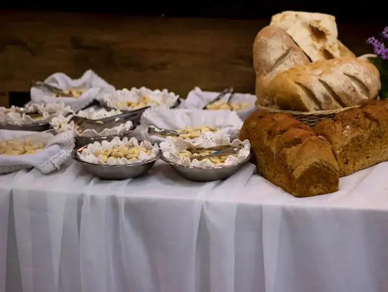 a table topped with a loaf of bread and bowls of food | Photo by Valentina Fischer, on https://unsplash.com/@palem?utm_source=centralapp&utm_medium=referral