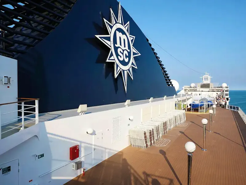 Image of Kiss & Fly Large msc cruise ship funnel and deck with ocean view. | Photo by HECTOR ELIZALDE, on https://unsplash.com/@hectorelizaldepina?utm_source=CentralApp&utm_medium=referral