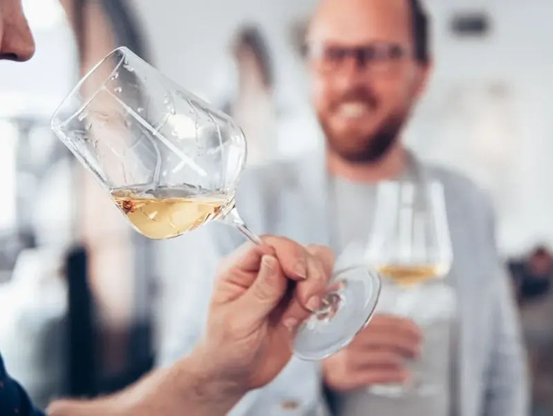 man in white sweater holding clear wine glass | Photo by Elle Hughes, on https://unsplash.com/@elletakesphotos?utm_source=centralapp&utm_medium=referral