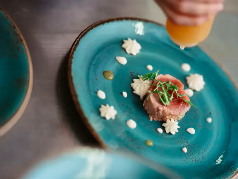 a blue plate with a small piece of food on it | Photo by Martin Baron, on https://unsplash.com/@elmartinbaron?utm_source=CentralApp&utm_medium=referral