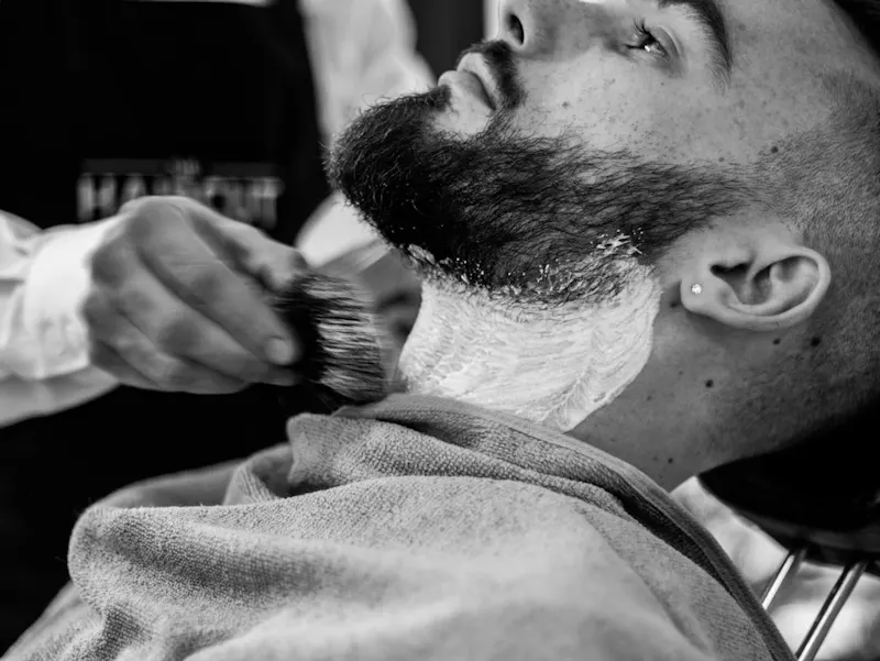 grayscale photo of man shaving his beard | Photo de Arthur Humeau, sur https://unsplash.com/@_aaarthy?utm_source=centralapp&utm_medium=referral