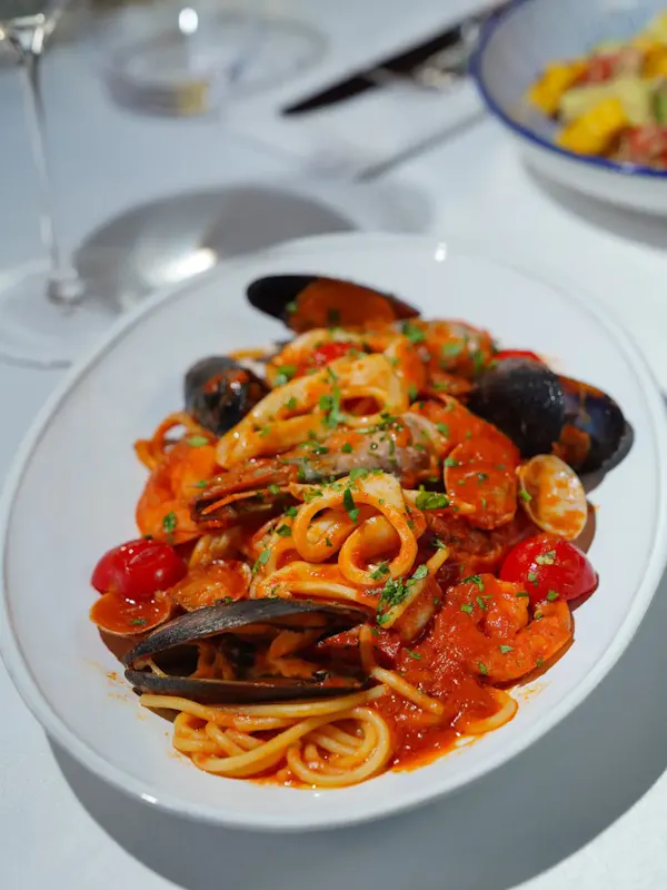 Close-up of a vibrant seafood pasta dish featuring mussels, clams, and a rich tomato sauce. | Photo by Nadin Sh, on https://www.pexels.com/@nadin-sh-78971847?utm_source=centralapp&utm_medium=referral